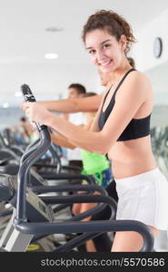 A young and beautiful woman working out at the gym