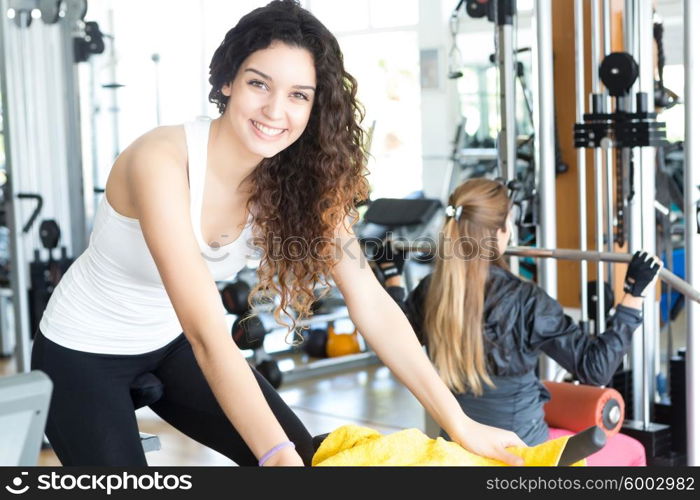 A young and beautiful woman working out at the gym