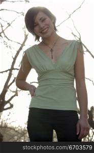 A young and casual woman in a park.