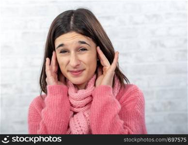 a young and pretty brunette woman with earache