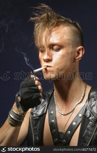 A young angry punk poses for the camera.