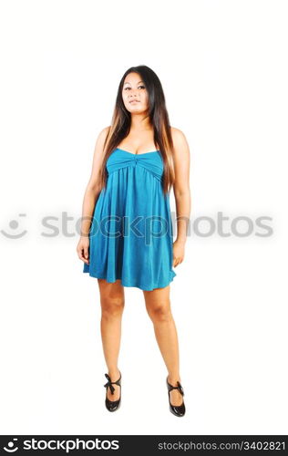 A young Asian long hair woman standing in an blue dress and high heels in the studio.