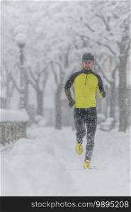 A young athlete with a beard during a run in the snow