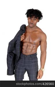 A young atlethic black man standing shirtless with his suit jacket overhis shoulder, showing his great body, isolated for white background