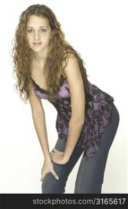 A young attractive model in a purple top with black lace and jeans