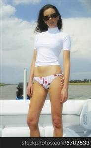 A young attractive woman enjouy her speedboat.