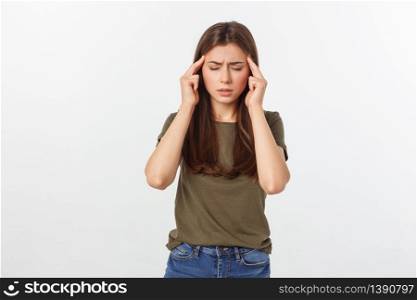 A young attractive woman suffering from illness or headache holding her head. Isolated on white.. A young attractive woman suffering from illness or headache holding her head. Isolated on white