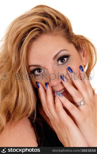 A young beautiful woman holding her finger on her face with her bluefingernails, isolated for white background.