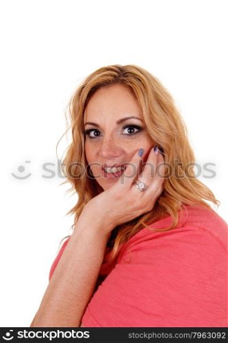 A young beautiful woman holding her hand on her face with her bluefingernails, isolated for white background.