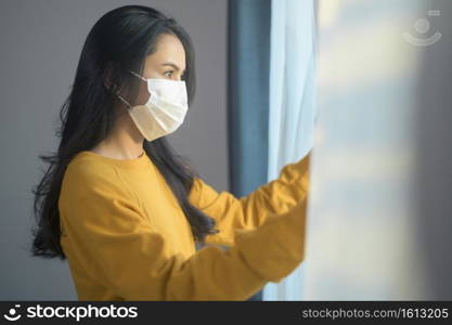 A young beautiful woman wearing a protective facial mask getting ready to go outside, Healthcare and covid-19 concept  . Young beautiful woman wearing a protective facial mask getting ready to go outside, Healthcare and covid-19 concept  
