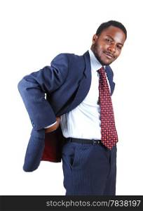 A young black business man standing in a blue suit and tie with his handsbehind his back, isolated for white background.