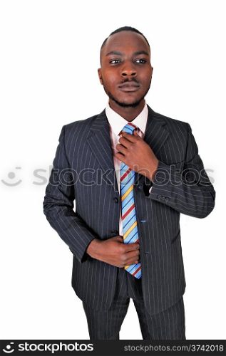 A young black business man standing in a suit and tie, fixing his tiefor white background.