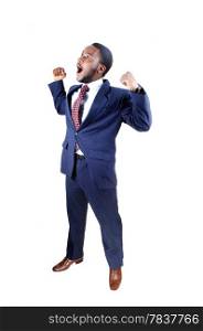 A young black business man standing in a suit and tie, holding up hishands and screaming for happiness, isolated for white background.