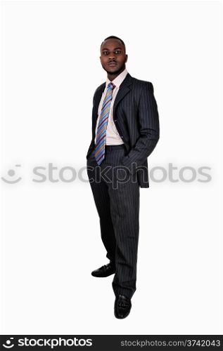 A young black business man standing in a suit and tie with his handsin his pocket for white background.