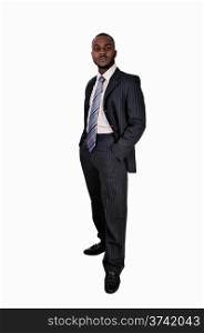 A young black business man standing in a suit and tie with his handsin his pocket for white background.