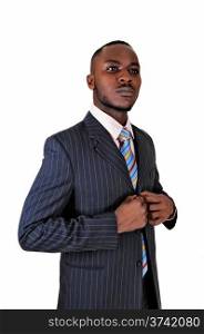 A young black business man standing in a suit and tie, with his handson his chest for white background.