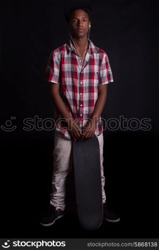A young black skater posing in studio