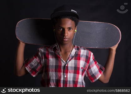 A young black skater posing in studio