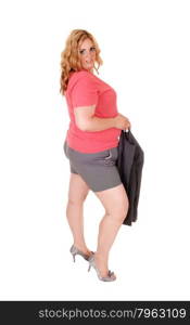 A young blond plus size woman in gray shorts holding her jacket in highheels standing isolated for white background.