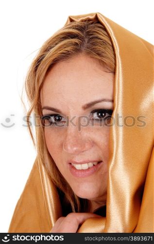 A young blond pretty woman with gold fabric around her head in closeupisolated for white background.