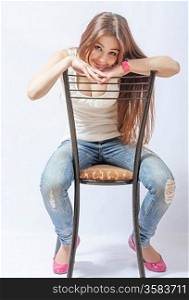 a young blond woman resting on chair