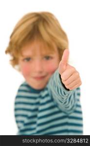 A young blonde boy gives a thumbs up to the camera, the focus is on his hand.