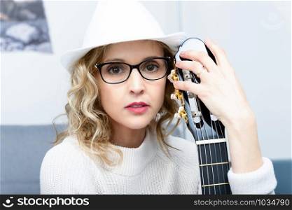 a young blonde woman with a acoustic guitar