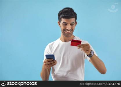 A young boy placing an order with his credit card and mobile phone. 