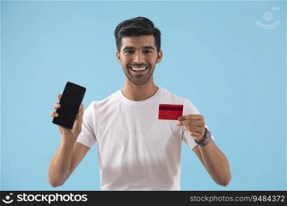 A young boy showing his credit card and mobile phone. 