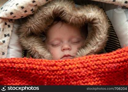 a young boy sleeping in the stroller