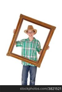 A young boy with a hat, holding a picture frame on front of him,isolated for white background.