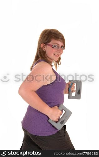A young brunet teenager doing exercises with hand weights and walking,smiling into the camera, for white background.