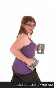 A young brunet teenager doing exercises with hand weights and walking,smiling into the camera, for white background.