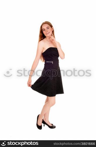 A young brunette woman in a black short dress standing isolatedfor white background.