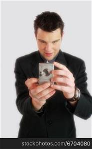 A young business man takes a photo with his digital camera