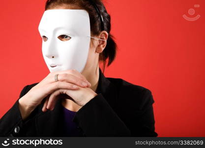 A young business woman behind a white mask