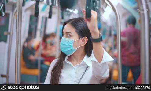 A young business woman is wearing face mask in public transportation , safety travel , covid-19 protection concept. .  A young business woman is wearing face mask in public transportation , safety travel , covid-19 protection concept. 