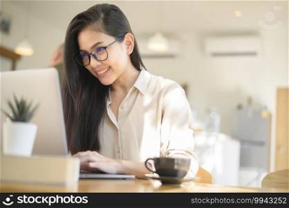 A young business woman working with her laptop in coffee shop. Young business woman working with her laptop in coffee shop