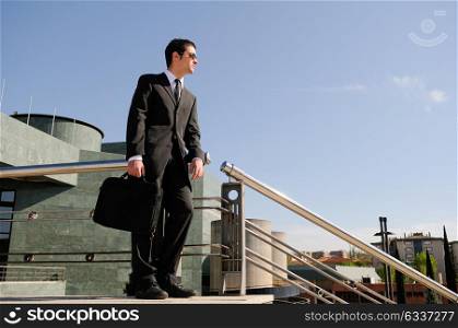 A young businessman holding a briefcase