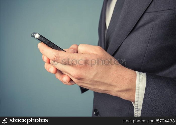 A young businessman is using his smart phone