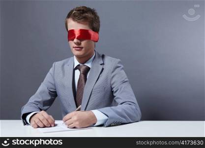 A young businessman signs a document with your eyes closed