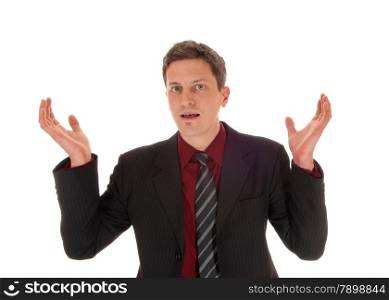 A young businessman standing for white background with his hands raised,is totally surprised.
