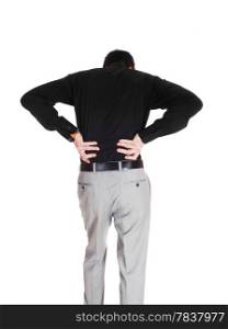 A young businessman standing from the back holding his hands onhis back for heavy back pain, isolated for white background.