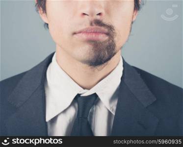 A young businessman with a half shaved beard