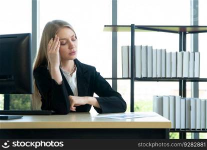 A young businesswoman suffering stress working at the office computer on desk cause of cant deliver the document on deadline. Concept of Difficulties in doing business entrepreneur