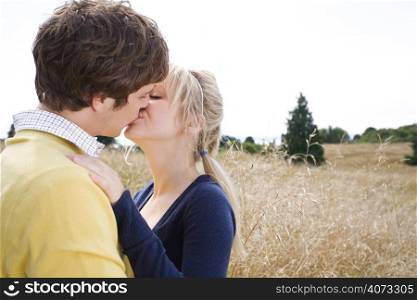 A young caucasian couple in love kissing outdoor
