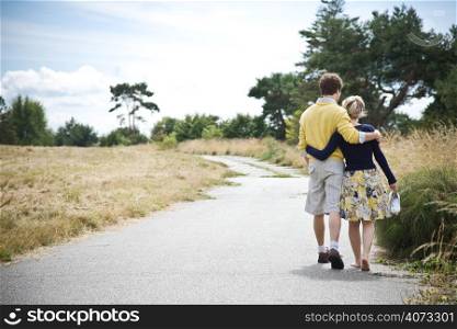 A young caucasian couple taking a walk in a park