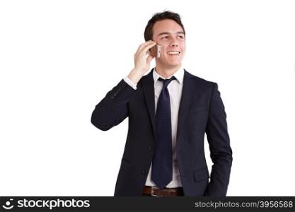 A young caucasian male businessman smiling holding a mobile phone looking away from camera.