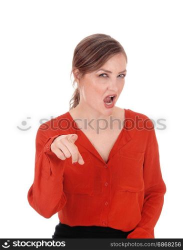 A young Caucasian woman in a red blouse pointing her finger andscreaming at you, isolated for white background