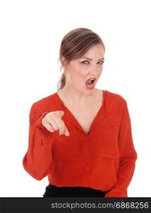 A young Caucasian woman in a red blouse pointing her finger andscreaming at you, isolated for white background